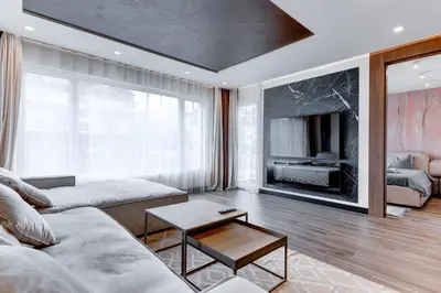 a living room with a couch and a tv at Amuse Bouche by Skabrin in Bansko