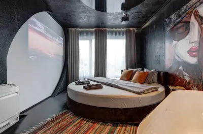 a bedroom with a bed in a room with a large window at Amuse Bouche by Skabrin in Bansko