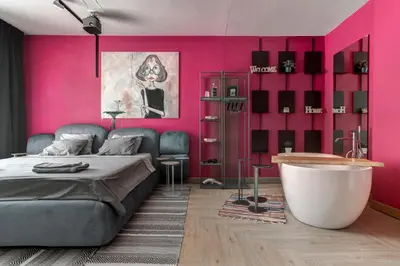 a bedroom with pink walls and a bed and a tub at Amuse Bouche by Skabrin in Bansko