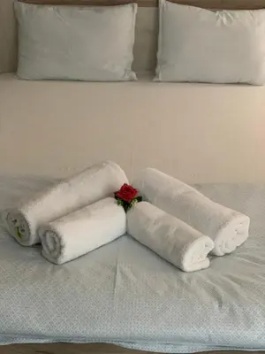a pile of towels sitting on a bed at Къщата на Анхел in Sofia