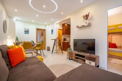 a living room with a couch and a flat screen tv at Premium comfy 2BDR Apt - Free Parking - Fast Wi-Fi in Sofia