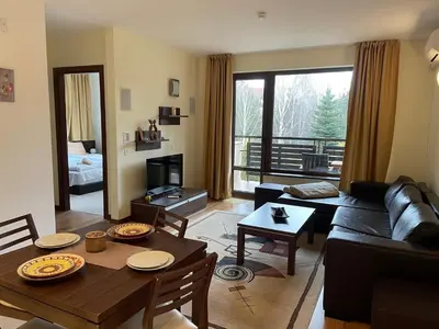 a living room with a couch and a table at Terra SP apartments-Razlog in Razlog