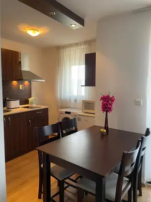 a kitchen and dining room with a table and chairs at Royal Park SP apartments-Bansko in Bansko