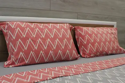 two red pillows sitting on top of a bed at Beautiful Apartment free Parking Garage in Plovdiv