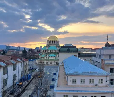a large building with a dome on top of it at Top-Center BestView Apartment in Sofia