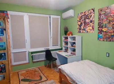 a bedroom with a bed and a desk and a window at Top-Center BestView Apartment in Sofia