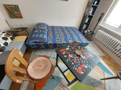 a living room with a table and a bed at Top-Center BestView Apartment in Sofia