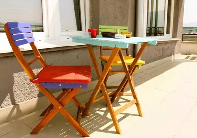 a table and two chairs sitting next to a table at Top-Center BestView Apartment in Sofia