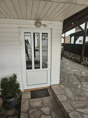 a man standing at the door of a house at Cтаи за гости Бърдареви in Bansko