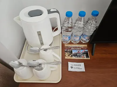 a blender and some bottles of water on a table at Cтаи за гости Бърдареви in Bansko