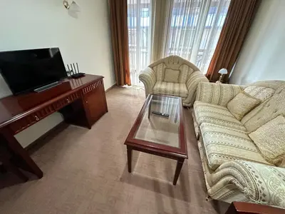 a living room with a couch and a table at Great apartments in Downtown in Bansko