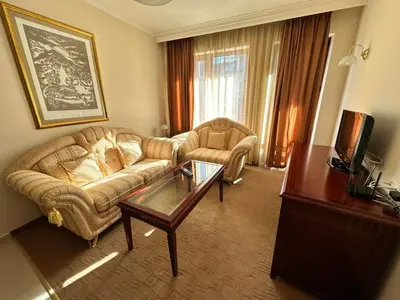 a living room with a couch and a coffee table at Great apartments in Downtown in Bansko