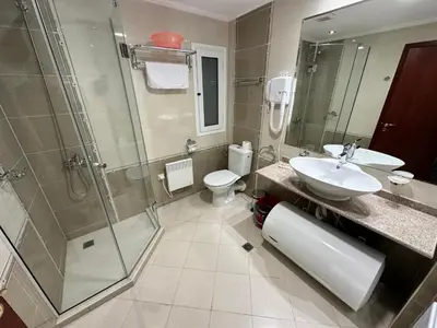 a bathroom with a sink and a shower and a toilet at Great apartments in Downtown in Bansko
