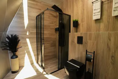 a bathroom with a shower and a toilet in a room at Glass Domes - by The Wind Mills Hydropark in Gorna Malina