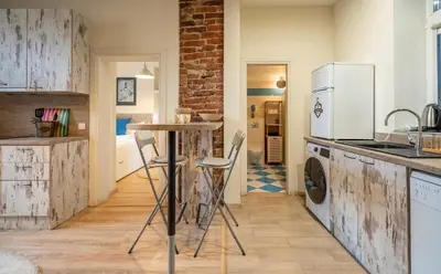 a kitchen with a table and a refrigerator at 'Blue Sapphire House'- central&modern in Sofia