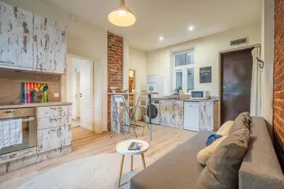 a living room with a couch and a kitchen at 'Blue Sapphire House'- central&modern in Sofia