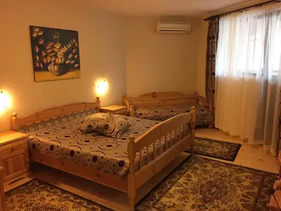 a bedroom with two beds and a window at Guest House Mira in Sapareva Banya