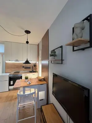 a kitchen with a table and a dining room at Cozy Boutique Apartment in Plovdiv in Plovdiv