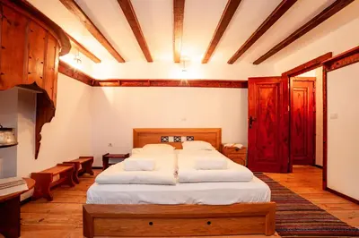 a bedroom with a large bed in a room at Къща за гости Родопчани in Smolyan
