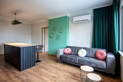 a living room with a couch and a table at Jungle apartment in the center in Sofia