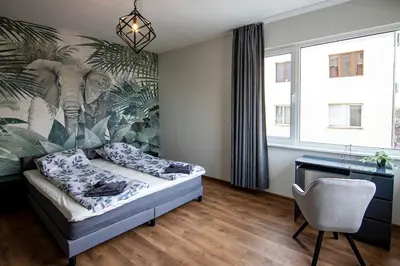 a bedroom with a bed and a desk and a chair at Jungle apartment in the center in Sofia