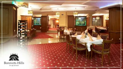 a dining room with tables and chairs in a restaurant at BH and Semiramida Ski Apartment in Borovets