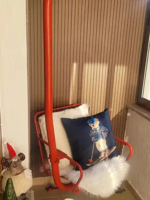 a small room with a chair with a snowman pillow at BH and Semiramida Ski Apartment in Borovets