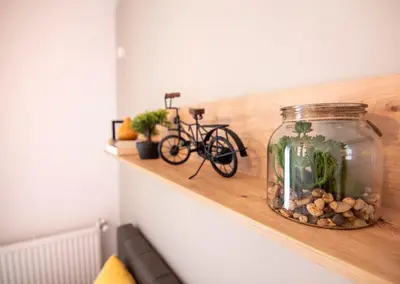 a bike sitting on a shelf with a jar of fish at Apartment with private parking 1 in Sofia