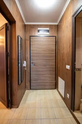 a large door in a hallway with wooden walls at Apartment with private parking 1 in Sofia