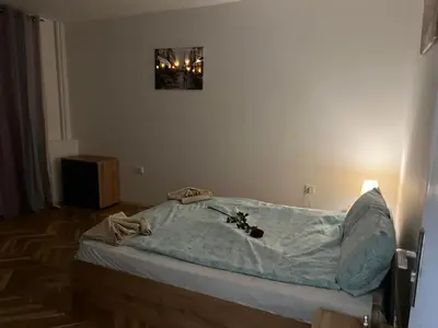 a hospital bed with a blue blanket on it at The white suite in Sofia
