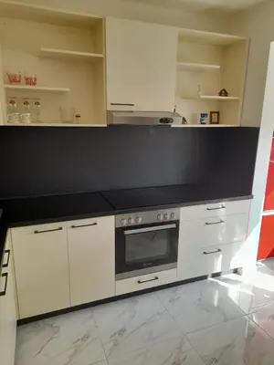 a kitchen with white cabinets and a stove top oven at The white suite in Sofia