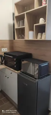 a black microwave on a counter in a kitchen at Apartment B45 Borovets Gardans in Borovets