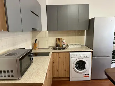 a kitchen with a refrigerator and a washing machine at Gramadeto two bedroom apartment next to Gondola in Bansko