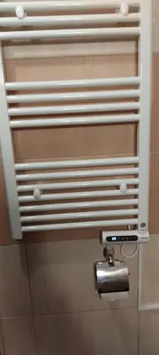 a toilet paper dispenser on a bathroom stall at Уютная квартира в комплексе Snow Lodge in Bansko