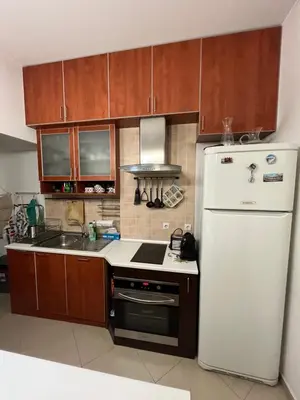a kitchen with a white refrigerator and a sink at Casa del Rey in Sofia