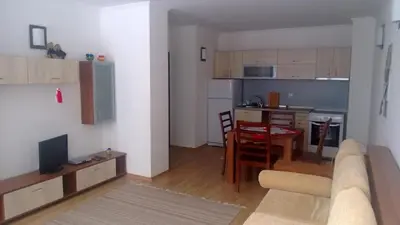 a living room and kitchen with a couch and a table at Vadjo Apartments in Complex Stenata Pamporovo in Pamporovo