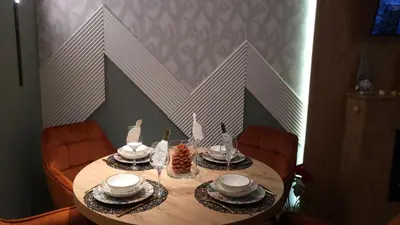 a dining room table with a table set with plates and bowls at Pinewood ANG premium luxurious apartment 15 in Borovets