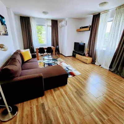 a living room with a brown couch and a wooden floor at Aпартамент-София/ Newhome lux apartment in Sofia