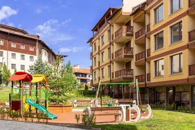 a playground in front of a apartment building at Pirin Sense apartment A11 in Bansko