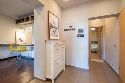 a kitchen and living room with white walls at Modern yet Rustic Style City Centre Apt 2BR/2BTH in Sofia