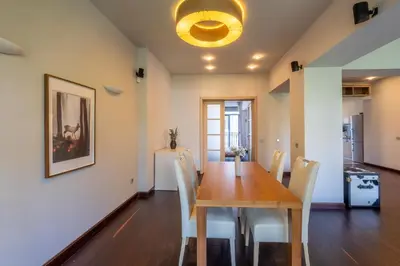 a dining room with a wooden table and chairs at Modern yet Rustic Style City Centre Apt 2BR/2BTH in Sofia