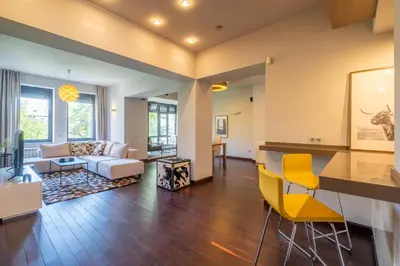 a living room with a couch and a table and chairs at Modern yet Rustic Style City Centre Apt 2BR/2BTH in Sofia