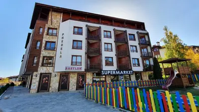 a building with a fence in front of it at TO FOUR+2 PREDELA 1 in Bansko