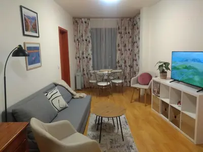 a living room with a couch and a tv at TO FOUR+2 PREDELA 1 in Bansko