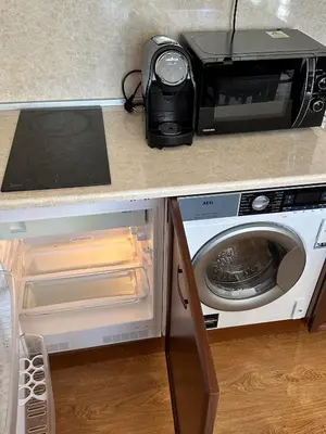 a toaster oven and a microwave on a kitchen counter at ELEA Apartment Mountain Lodge Pamporovo in Pamporovo