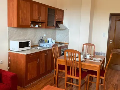a small kitchen with a table and a microwave at Cedar Heights Cozy Apartments in Pamporovo
