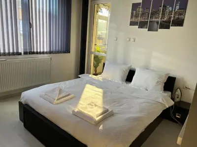 a bedroom with a bed with two towels on it at Apartament Kamarashki in Troyan