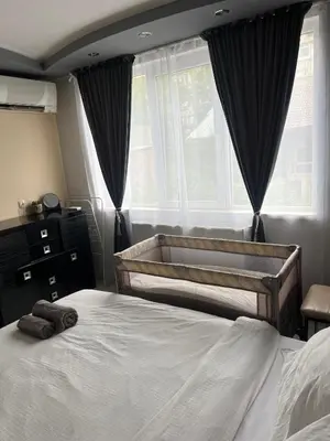 a bedroom with two beds and a window at Apartament Kamarashki in Troyan