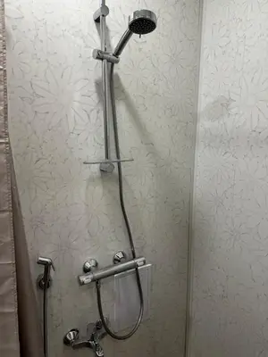 a shower with a shower head in a bathroom at Апартамент Миели in Sofia