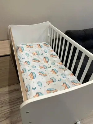 a white crib with a blanket on it at Апартамент Миели in Sofia